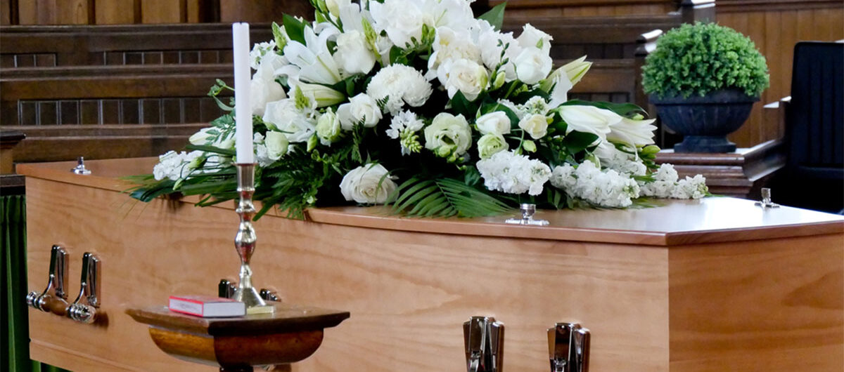 closeupshotofacolorfulcasketinahearse-2