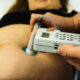 midwifeexaminingbellyofpregnantwomanwithctgscanning-pregnant