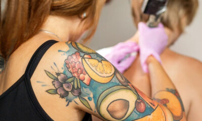 youngwomanwithsleevetattooatthework-tattoosession